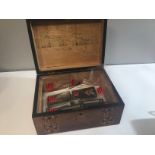 A Walnut inlaid box containing German Army shoulder straps and epaulets.