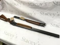 A 12 gauge over and under shotgun with walnut stoc
