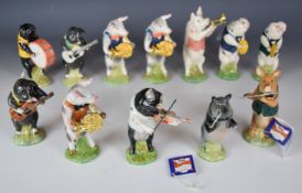 Twelve Beswick Pig Promenade band figures including three limited editions, made for Sinclairs,