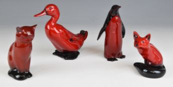 Four Royal Doulton flambé animals comprising seated fox, penguin, cat and duck, tallest 15cm