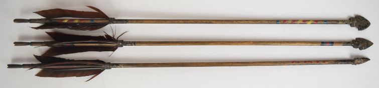 Three Native American style arrows with painted shafts and flint heads, length 65cm