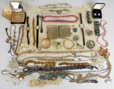 A collection of costume jewellery including vintage necklaces, brooches, Stratton compact, Art
