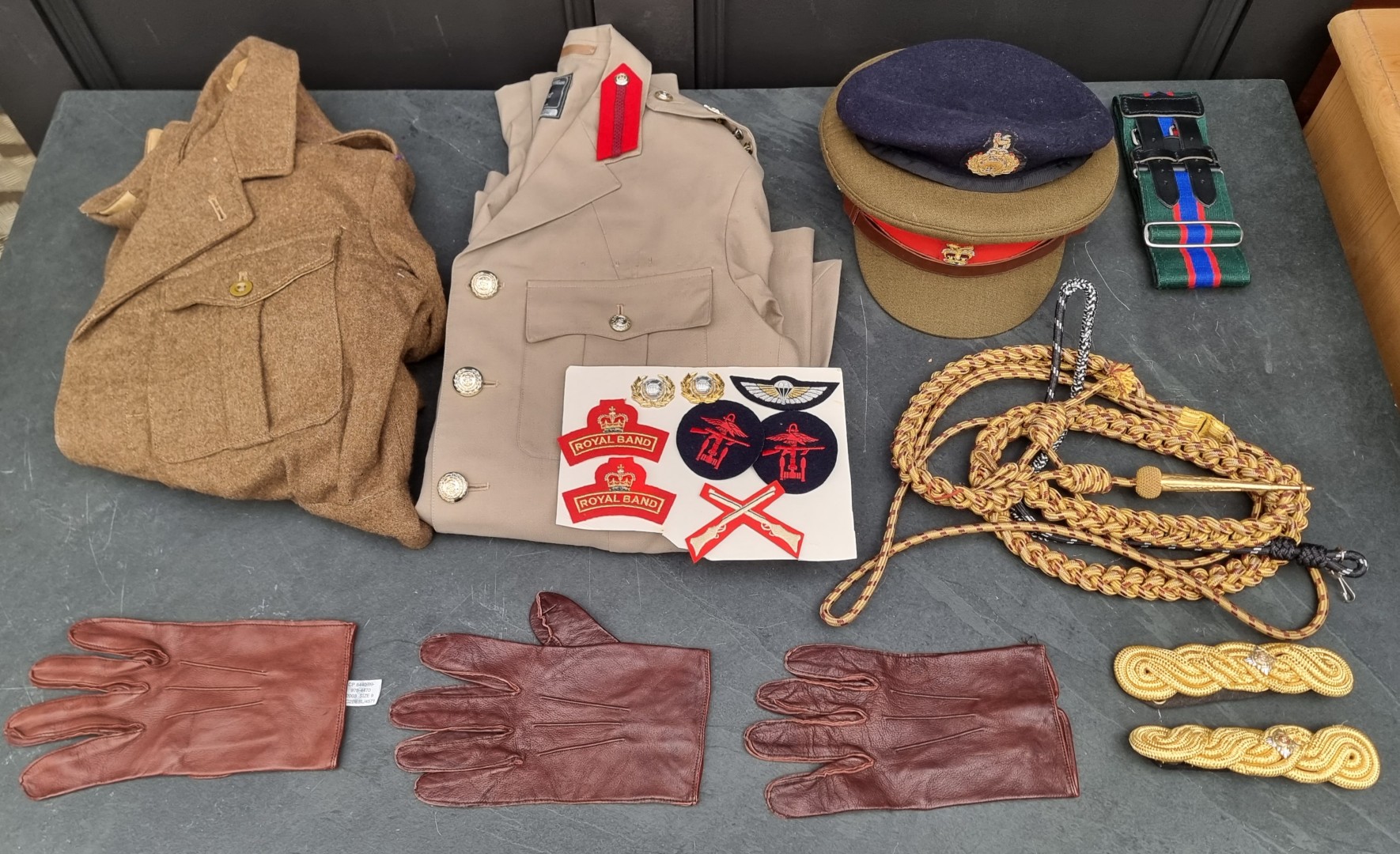 A group of Royal Marines uniform items, to include: a Brigadiers tropical tunic; a peaked cap; a