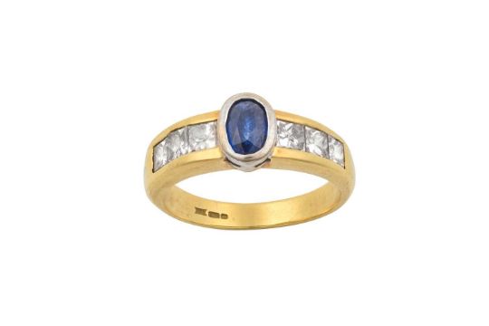 An 18 Carat Gold Sapphire and Diamond Ring the oval cut sapphire in a white claw setting, to - Image 1 of 4