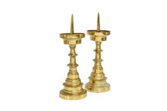 A Pair of Bell Metal Pricket Candlesticks, probably Dutch, 17th century, on blade-knopped stems