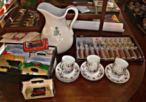 An earthenware water pitcher inscribed G.V.R set of steak knives and forks, with coffee cups and a