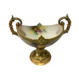 Royal Worcester two-handled tazza painted with roses by M Blake with green/gilt base, 18cm.