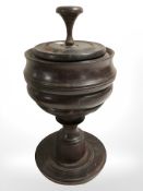 A turned wooden tobacco jar, height 27 cm.