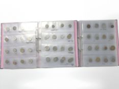 Two folders of world coins.