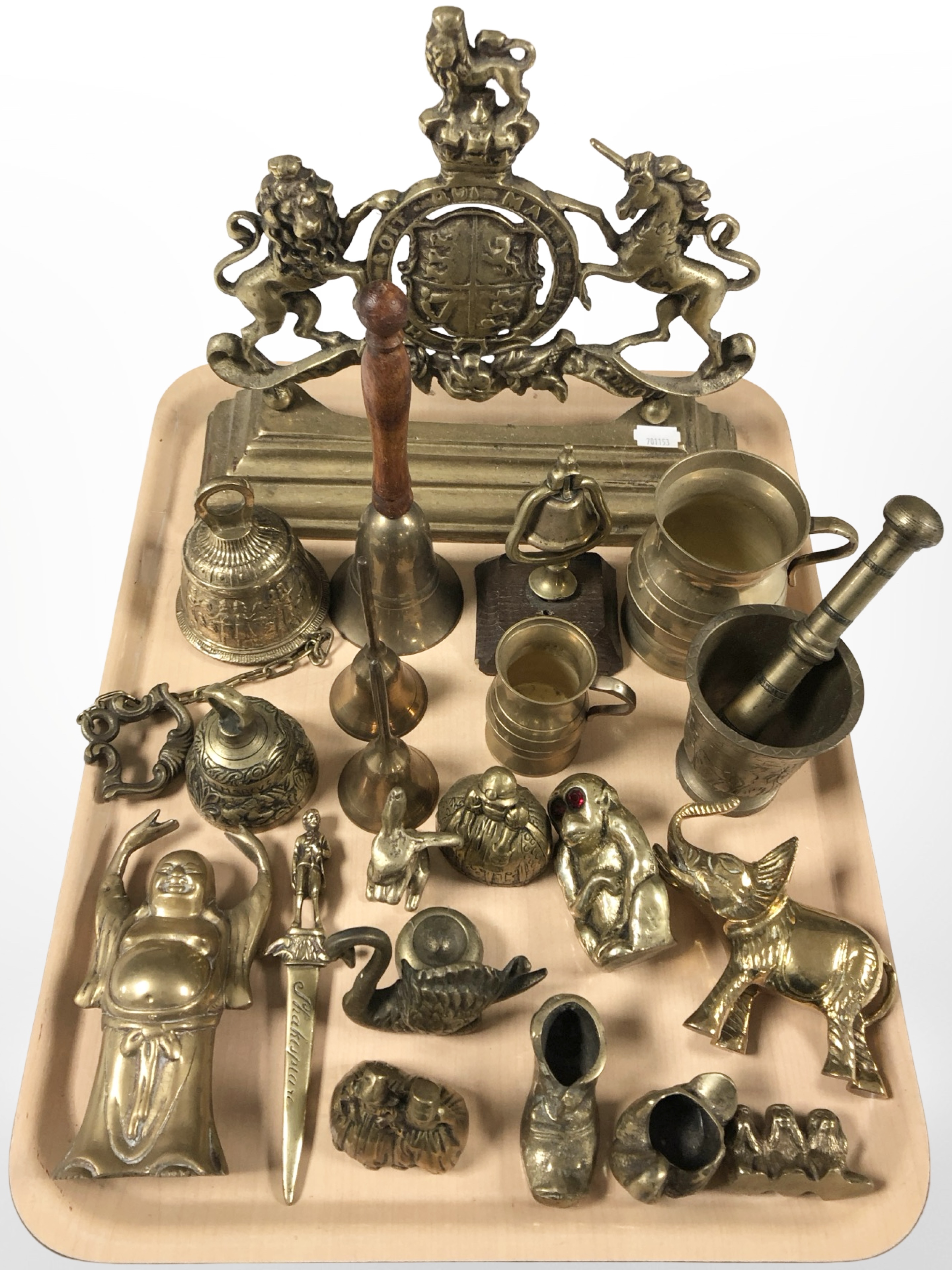 A group of brass ornaments, royal crest doorstop, letter knife, mortar and pestle, etc.