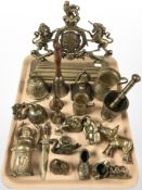 A group of brass ornaments, royal crest doorstop, letter knife, mortar and pestle, etc.