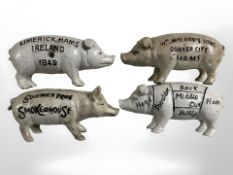 Four painted cast iron pig money banks, length 19 cm.
