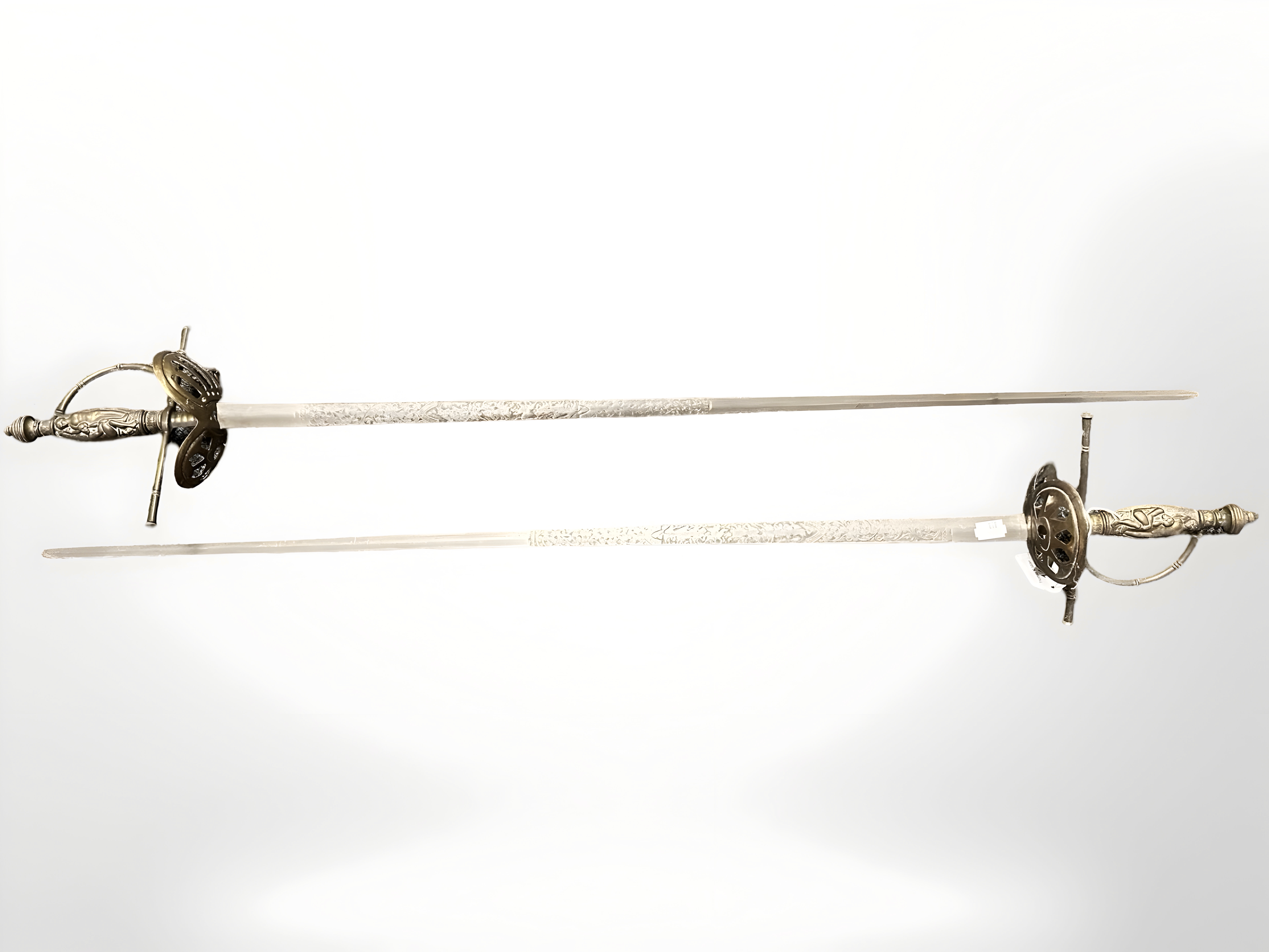 A pair of 19th century Continental court swords, with 83 cm engraved blades,