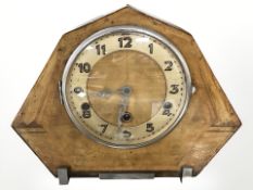 An Art Deco style mantel clock with pendulum and key.