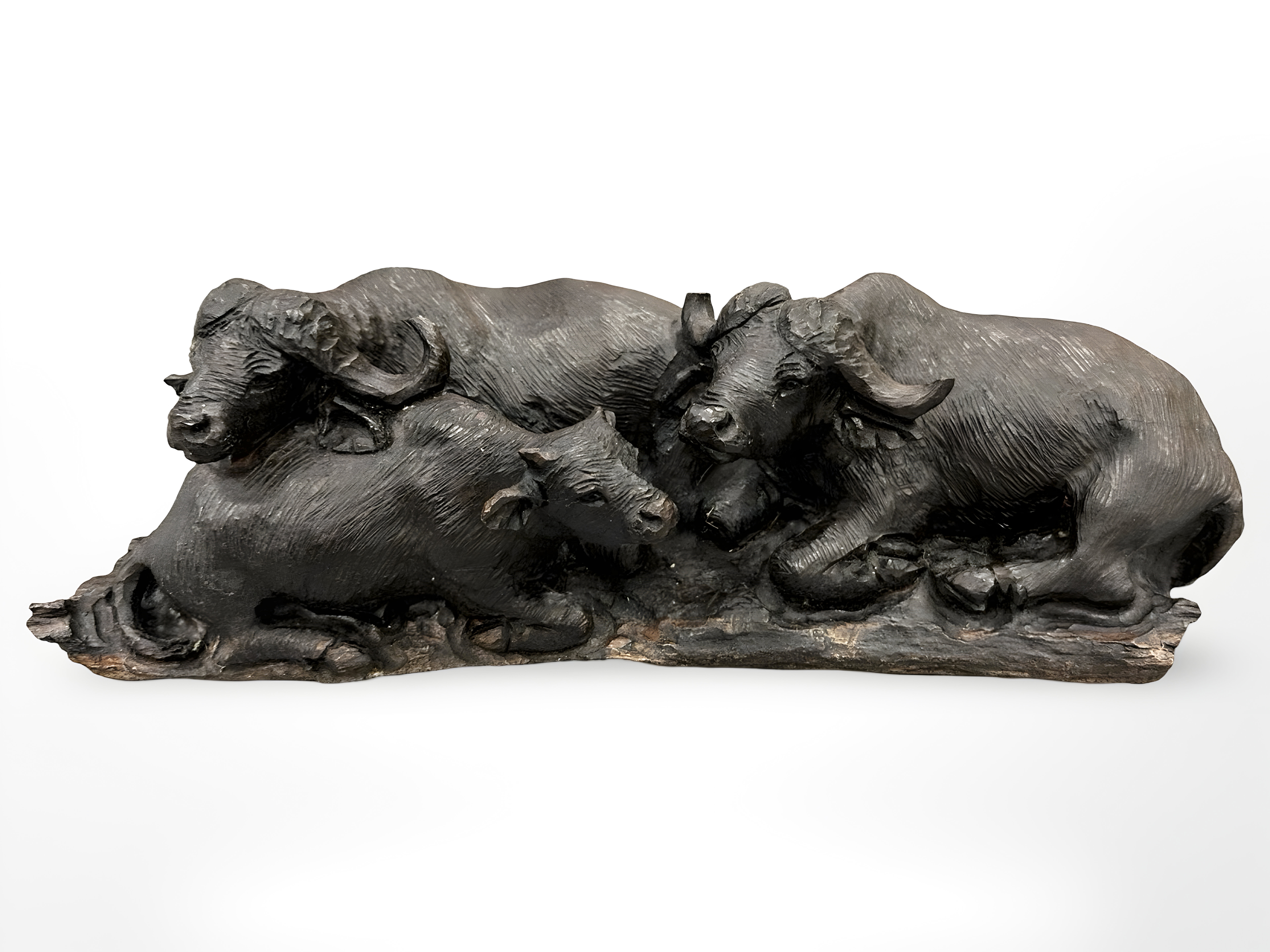 A carved hardwood water buffalo figure group on wooden carved plinth,