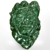 A large malachite plaque carved as a face, approximately 25 cm x 17 cm, 3.2kg.