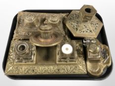 A group of ornate brass desk stands and ink wells.