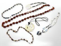 A polished red agate lozenge shape necklace, length 90 cm,