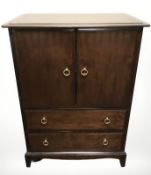 A Stag linen cabinet fitted cupboard and two drawers beneath, 84 cm wide.