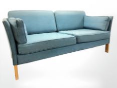 A late 20th century two seater settee in light blue upholstery,