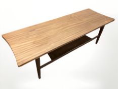 A 20th century teak shaped rectangular two tier coffee table, length 122 cm.