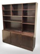 A Danish teak open bookcase fitted cupboards beneath,