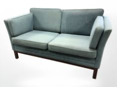 A late 20th century Danish two seater settee in blue upholstery, length 148 cm.