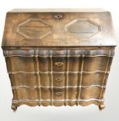 A 19th century oak serpentine front bureau, 112 cm x 60 cm x 115 cm.