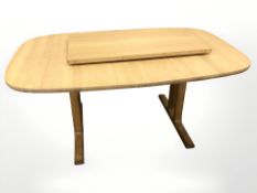 A Danish blonde oak extending dining table, with leaf, total length 213 cm x 100 cm x 72 cm.