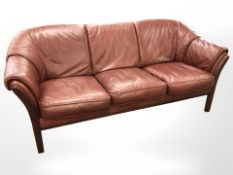 A stained beech framed Burgundy three seater settee, length 193 cm.
