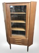 A 20th century Danish glazed teak corner cabinet,
