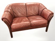 A stained beech framed Burgundy two seater settee, length 141 cm.
