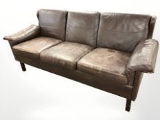 A late 20th century Danish brown leather three seater settee, length 200 cm.