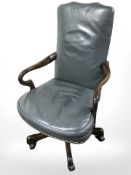 A reproduction brass studded leather upholstered swivel desk chair.