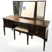 A Stag five drawer mirror back dressing table and a matching stool, 152 cm wide.
