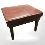 An oxblood leather footstool, width 53 cm.