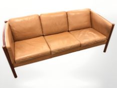A late 20th century Danish wood framed tan leather three seater settee, length 200 cm.