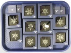 A group of Swarovski crystal Christmas ornaments, all boxed.