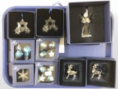 A group of Swarovski crystal Christmas ornaments, all boxed.