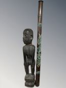 An African hardwood carving of a man, height 87 cm, together with an Australian didgeridoo.