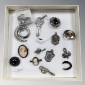 A group of silver brooches, key, cameo brooches, etc.