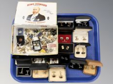 A collection of cufflinks, enameled lapel pins, etc.