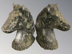 A pair of weathered concrete horse head busts, height 46 cm.