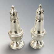 A pair of loaded silver sifters, stamped 'Birks Sterling', height 12.5 cm.