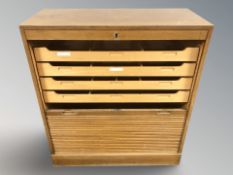 An early 20th century continental oak tambour front office filing cabinet, with working key,
