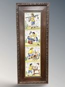 An oak framed panel of Delft tiles depicting figures working on land,