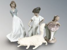Three Nao figures of girls and a Royal Doulton cat.
