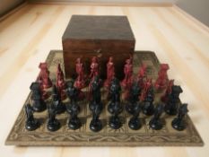 A set of stained resin Napoleon-themed chess pieces, with wooden storage box and cast resin board,