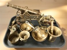 A brass model cannon on carriage, together with a wall sconce, mortars and pestles, temple bell,
