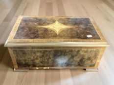 A Swiss walnut, amboyna, and satinwood-inlaid cylinder music box,